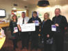 Members of Octave presenting our donation to the Hospice